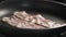 Bacon roasting on a pan closeup 180fps slow motion