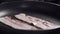 Bacon roasting on a pan closeup 180fps slow motion