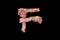 Bacon shaped as the word F on black background