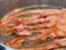 Bacon Sizzling in hot skillet.