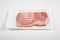 Bacon slices on the package, on white background