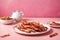 Bacon strips on a plate with pink background