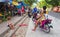 Bacong, Philippines: 26 June, 2016: Big family on pink motorbike by local market.