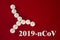 Bacterial cell made of white tablets with the inscription 2019- nCoV on a red background, top view. 2019 Novel Coronavirus 2019-