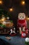 Bad christmas mood, loneliness concept. Unhappy cat in red knitted sweater under the christmas tree with cake and decorations.