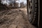 Bad country road. A dirt road damaged by the wheels of a heavy truck. Clay, dirt. Concept: problem with the roads; human impact on