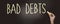 Bad debts words phrase with chalk on blackboard. Financial liabilities bankruptcy debt crisis concept