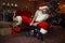 Bad drunk Santa claus riding on little toy car