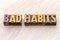 Bad habits word abstract in wood type