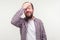 Bad memory. Portrait of forgetful embarrassed bearded man making facepalm gesture, feeling regretful. white background