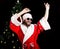 Bad rastoman Santa Claus smiles and fun dancing on the background of Christmas tree