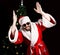 Bad rastoman Santa Claus smiles and fun dancing on the background of Christmas tree