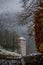 Bad Reichenhall, castle tower in winter background with snowy forest.