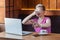 Bad smell. Portrait of unhappy confused young woman with short hair in pink t-shirt and eyeglasses is sitting in cafe, covering