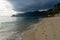 Bad weather moving over mountains onto the ocean and beautiful golden beach