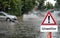 Bad weather warning sign flooded roads in German