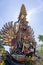 Bade cremation tower with traditional balinese sculptures of demons and flowers on central street in Ubud, Island Bali, Indonesia