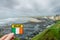 Badge with sign Ireland and Irish National flag in focus, Lahinch town out of focus, county Clare, Ireland, Low cloudy sky and