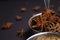 Badian. Star anise closeup in a metal bowl on a black background. Indian sweet spices for cooking.