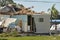 Badly damaged mobile home after hurricane Ian in Florida residential area. Consequences of natural disaster