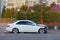 badly damaged passenger car stands in an empty parking lot