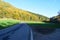 badly damaged road in colorful autumn landscape