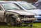 Badly damaged rusted car after road accident