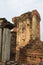 Badly eroded standing Buddha statue on west facing wall of mondop image hall, Sukhothai Historical Park, Thailand