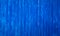 Badly painted waved metal sheet blue background