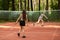 Badminton in park, two girls players play with rackets and shuttlecock on badminton court, sport and fitness outdoor