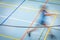 Badminton player in fast motion on a badminton court in a gymnasium