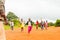 Bafoussam, Cameroon - 06 august 2018: young smiling african girls and boys running and having fun outside poor village school duri