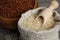 Bag and bowl with different sorts of rice on table, closeup