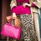 Bag close-up in female hands. Stylish modern and feminine image, style. Girl with gloves in a coat and with a pink bag