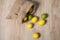 Bag of lemons and lime. Fabric bag with lemons. Full sack of lemons on a wooden background