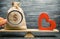 Bag with money and red wooden heart on the scales. Money versus love concept. Passion versus profit. Family or career choice.