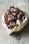 Bag of roast sweet chestnuts on a wooden background