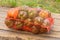 A bag of sweet peppers on wooden background. Fresh and tasty peppers good for health