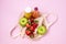 Bag with Two Bottles of Citrus Juice Green Apples Ripe Strawberry Diet Food Top View Horizontal Pink Background