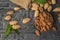 A bag of unpeeled almonds and a wooden bowl of peeled almonds. Flat lay