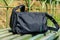 Bag on wooden bench at a railroad station at countryside