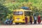 BAGAN, MYANMAR - DECEMBER 1, 2016: Yellow bus with monks on the roadside. Copy space for text.
