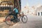 Bagan, Myanmar - March 2019: Burmese man parking bicycle in the backyard of Ananda temple