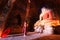 BAGAN, MYANMAR - May 2016: Monk burning candles in front of Buddha statue inside pagoda on May, 2016 in Bagan.