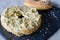Bagel with hummus, herbs and sesame seeds. Close up
