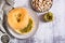 Bagel with pistachio cream butter for breakfast on a plate on the table top view