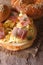 Bagel with scrambled eggs and bacon close-up vertical