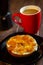 Bagel sponge cake breakfast with apple jam and coffee in red cup and Italian coffee pot on wooden table