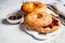 Bagels with peanut butter and berry jam on white board. Vegan food concept