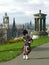 Bagpiper busker in Edinburgh, vertical cityscape